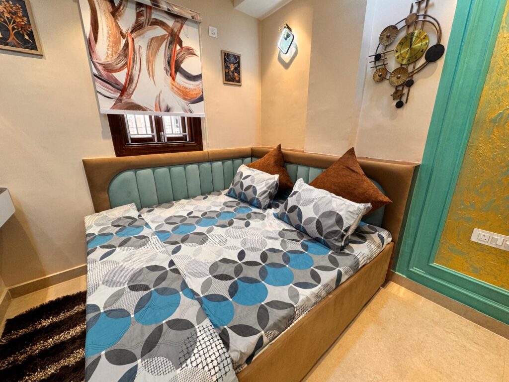 Compact bedroom with designer bed and wall decor