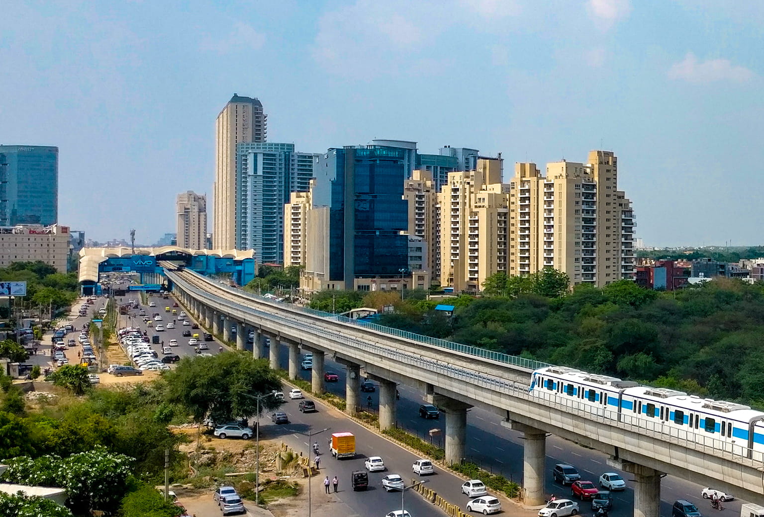 Modern apartments with Delhi Metro and city road view